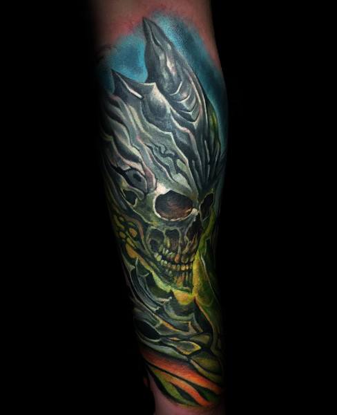 Dark fantasy tattoo of a skeletal Lich King-inspired figure from World of Warcraft, featuring glowing green energy and intricate armor, inked on the forearm.