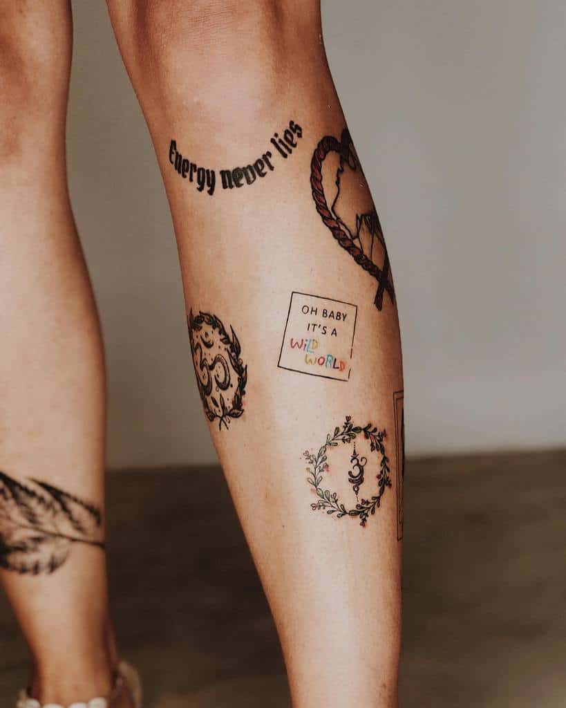 Leg tattoo collection featuring various designs, including the phrase 'Energy never lies,' a heart, an Om symbol inside a floral wreath, and a quote reading 'Oh baby it's a wild world.'