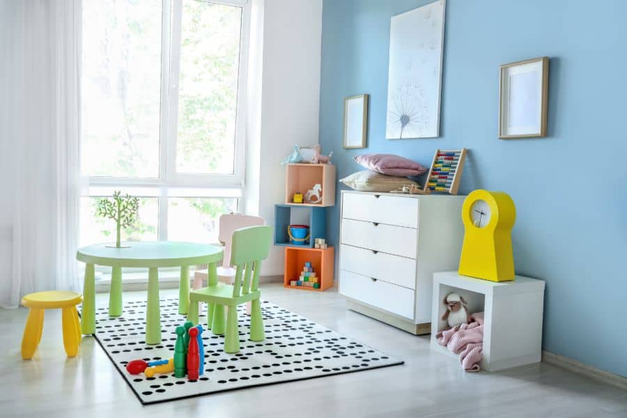blue accent wall kids room with green table and chair