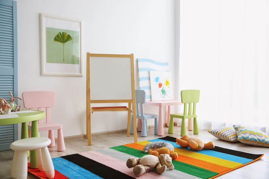 cute kids playroom with whiteboard and table and chairs