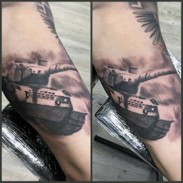 Black and grey tattoo of a tank with a dramatic perspective, surrounded by smoke and clouds for a moody, battlefield atmosphere.