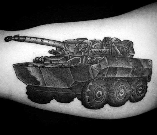 Black and grey tattoo of a wheeled armored tank with angular plating, bold lines, and textured shading for a strong, mechanical look.
