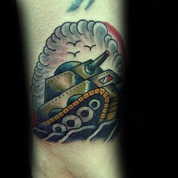 Traditional-style tank tattoo with bold outlines, muted green and yellow tones, puffy smoke cloud, and flying birds in the background.