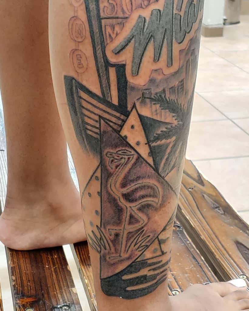 Leg sleeve tattoo featuring a Miami sign, palm trees, and a flamingo inside a geometric shape