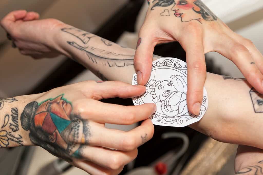 Tattoo Artist Applies Stencil To Forearm (2)