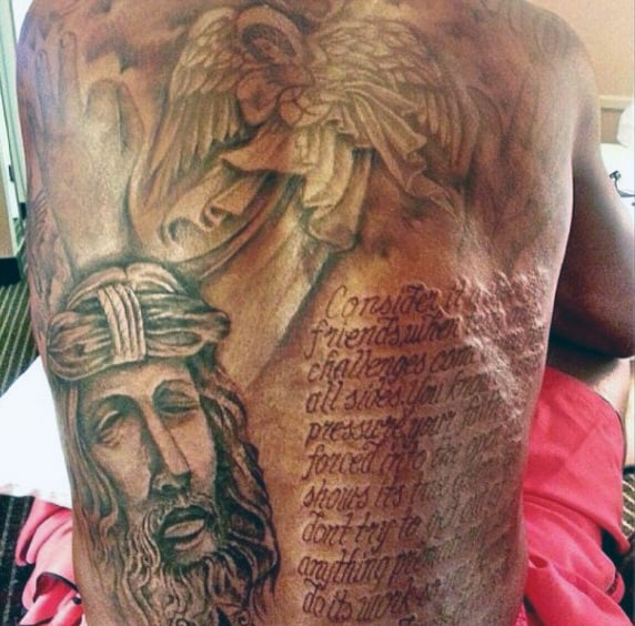 A person's back with a detailed religious tattoo and an inscribed text