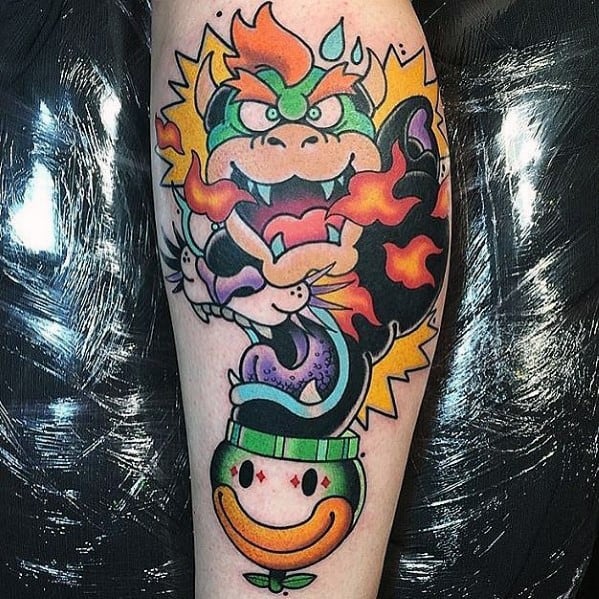 Vibrant Bowser tattoo on a man's leg featuring bold colors, dynamic fire effects, and a playful Clown Car for a striking Mario-themed design.