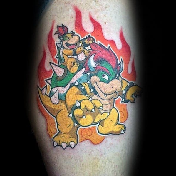 Bold Bowser and Bowser Jr. tattoo on a man's leg featuring vibrant colors, dynamic fire effects, and a powerful pose in a classic Mario-inspired design.