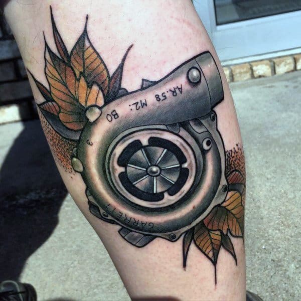Realistic **Garrett turbocharger** tattoo with autumn leaves, blending mechanical power with nature, symbolizing speed, change, and passion for cars.