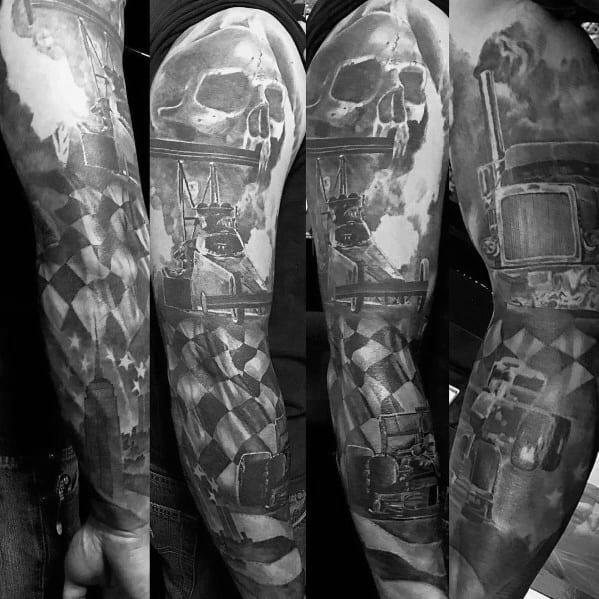 Detailed full-sleeve tattoo featuring a checkered flag, skull, racing truck, and industrial elements, symbolizing speed, power, and determination.
