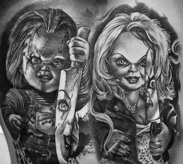 Black and grey Chucky and Tiffany tattoo with intense shading, featuring their sinister grins, stitched faces, and bloodied knives for a chilling horror design.