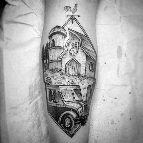 Black and gray tattoo of a farm scene with a barn, silo, rooster weather vane, and a vintage truck below in a diamond frame.