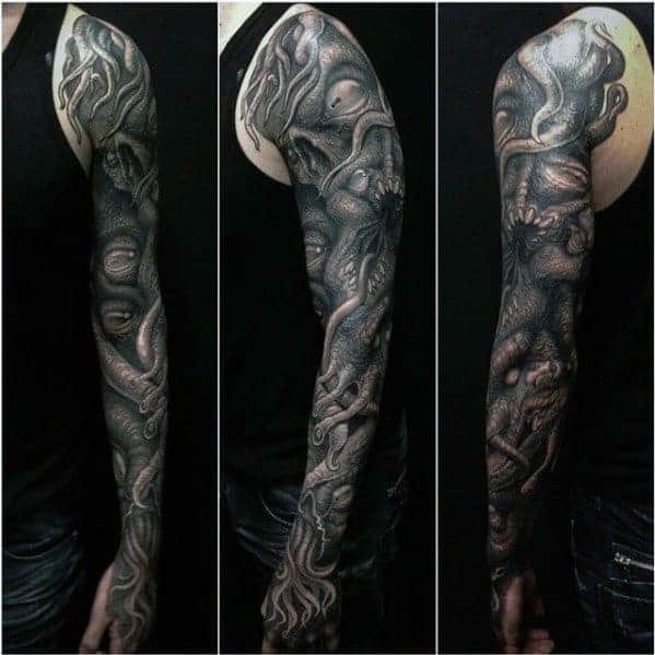 Full sleeve black-and-grey tattoo with intricate, organic, and abstract designs