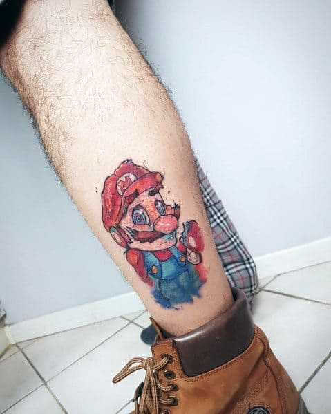 Watercolor-style *Super Mario* tattoo featuring abstract splashes and expressive shading, giving Mario a unique, artistic, and surreal appearance.