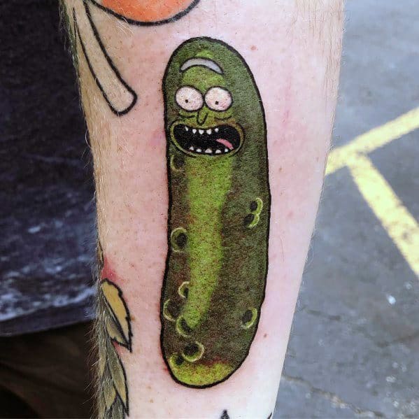 Classic Pickle Rick tattoo with bold outlines, realistic green shading, and his signature expression, placed on the forearm.