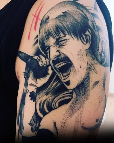 Upper arm tattoo featuring a detailed black and grey portrait of a passionate singer mid-performance, inspired by Red Hot Chili Peppers.