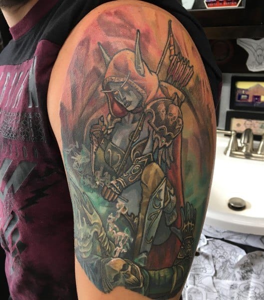 Detailed tattoo of Sylvanas Windrunner from World of Warcraft, wearing a hood and armor, holding a bow, with a fallen figure, inked on upper arm.