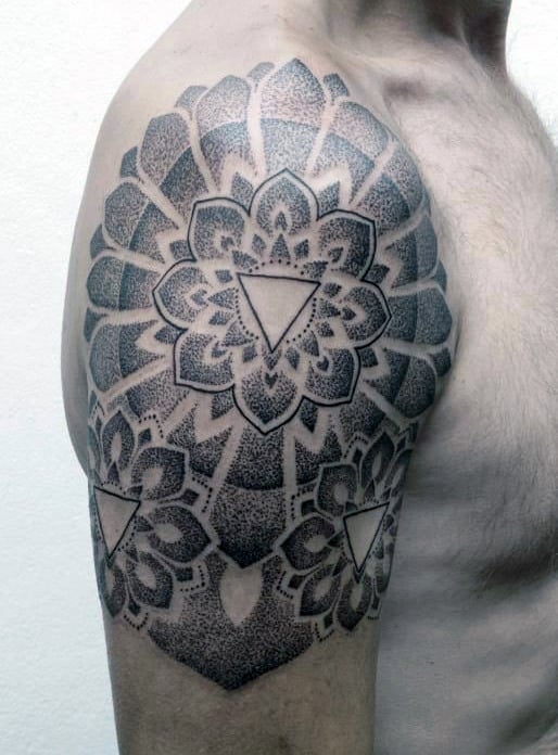Geometric flower tattoo on a person's upper arm and shoulder