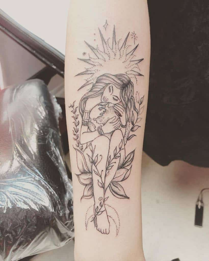 Elegant black ink tattoo of a woman embracing the Earth, surrounded by leaves and radiant light, and crescent moon in her feet