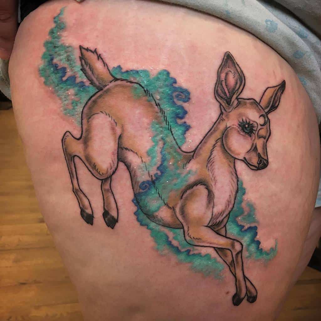 A tattoo of a leaping deer with a background of blue and green swirls