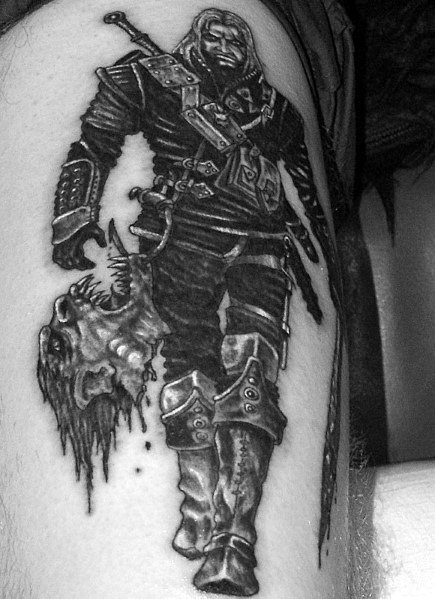 Geralt tattoo in black and gray, depicting him in full armor holding a monster’s severed head, showcasing his fearless and battle-hardened nature.