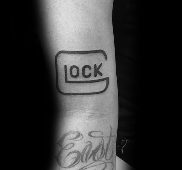 Black ink tattoo of the Glock logo on the forearm, featuring a simple yet bold design with clean lines for a striking and minimalist look.