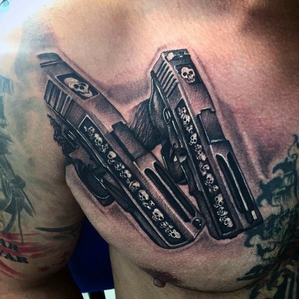 Realistic black and grey tattoo of two Glock pistols crossed on the chest, featuring intricate skull engravings on the slides for a bold and edgy design.