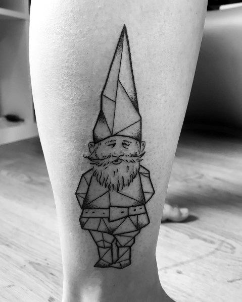 Black and white geometric tattoo of a gnome with a tall pointed hat, bushy beard, and hands behind his back, created with angular shapes and clean lines.