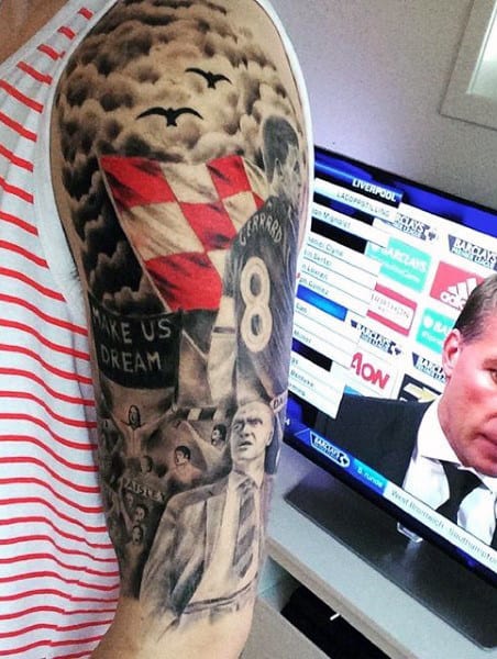 Person with a detailed arm tattoo watching a sports news channel on TV