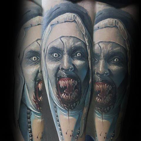 Realistic color tattoo of Valak from *The Nun*, featuring glowing eyes, sharp fangs, and eerie shading for a terrifying and haunting horror design.