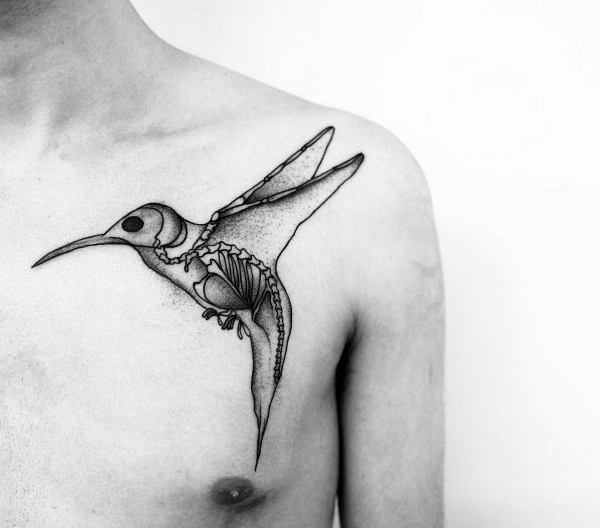 Minimalist chest tattoo of a hummingbird in flight with exposed skeletal and anatomical details inside the body.