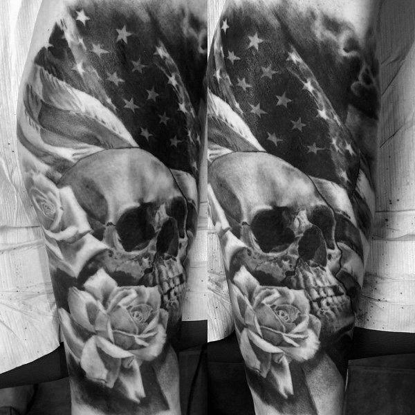 Black and grey tattoo of a skull with roses and an American flag in the background, blending realism and patriotic symbolism.