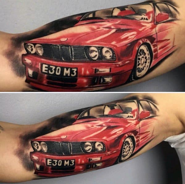 Vibrant BMW E30 M3 tattoo on arm, featuring bold red color, dynamic motion effects, and detailed shading for a striking automotive design.