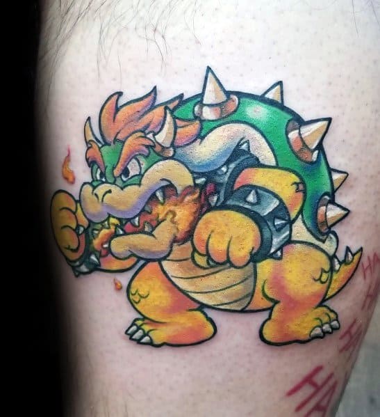 Fiery Bowser tattoo on a man's leg featuring bold outlines, vibrant colors, and a dynamic pose with flames for a striking Mario-inspired design.