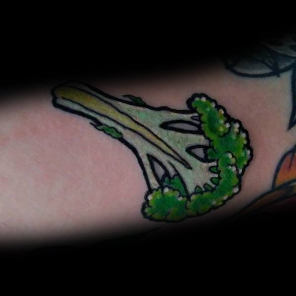 Small broccoli tattoo with bold outlines and vibrant green shading, creating a simple yet eye-catching design on the skin.
