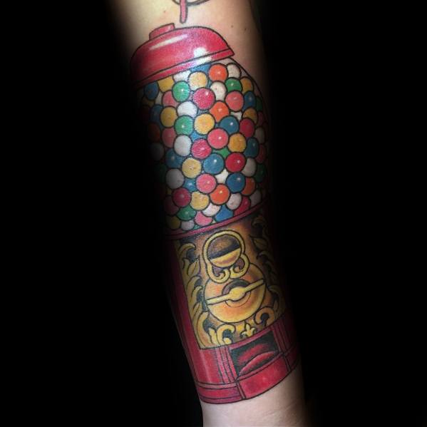 Colorful gumball machine tattoo with vibrant shading and intricate details, creating a nostalgic and eye-catching design on the forearm.