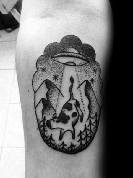 Blackwork tattoo of a UFO abducting a cow in a forested mountain scene, with bold lines and dotwork stars in the sky.