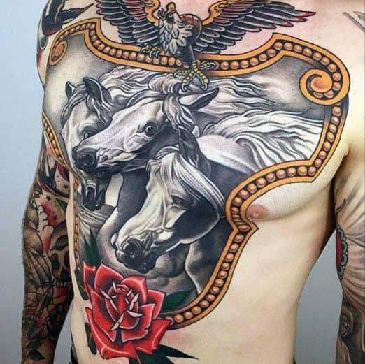 Chest tattoo of three horses, an eagle, and a red rose surrounded by ornate design