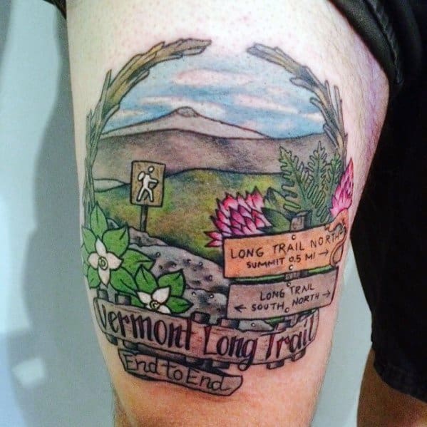 Colorful tattoo of Vermont’s Long Trail featuring a mountain path, wildflowers, and trail signs, symbolizing hiking and adventure.