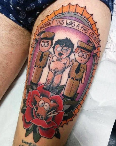 South Park tattoo of Randy Marsh being arrested, with 'I Thought This Was a Free Country' text, police officers, and a pig-faced rose design.