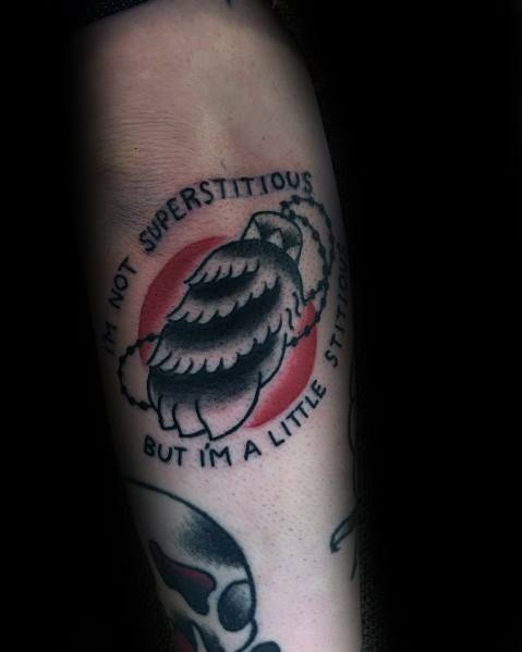 Black and white tattoo of a broken fortune cookie with the quote "I'm not superstitious, but I'm a little stitious," referencing Michael Scott's iconic line from *The Office*.