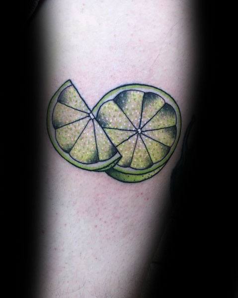 Realistic lime slice tattoo with vibrant green shading and fine details, creating a fresh and dynamic citrus-inspired design.