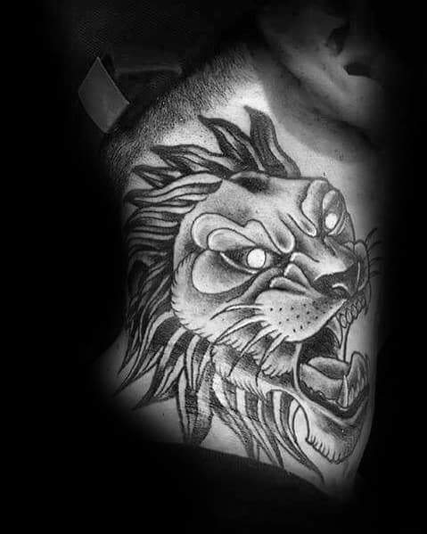 Fierce roaring lion neck tattoo with glowing eyes and bold shading, creating an intense and powerful design that symbolizes strength and dominance.