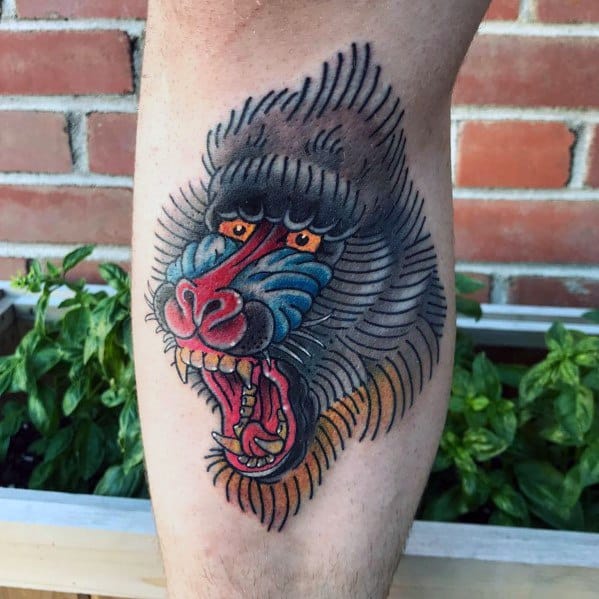 Neo-traditional baboon tattoo with bold outlines, vibrant colors, and dynamic shading, featuring a fierce open-mouthed expression for a striking design.