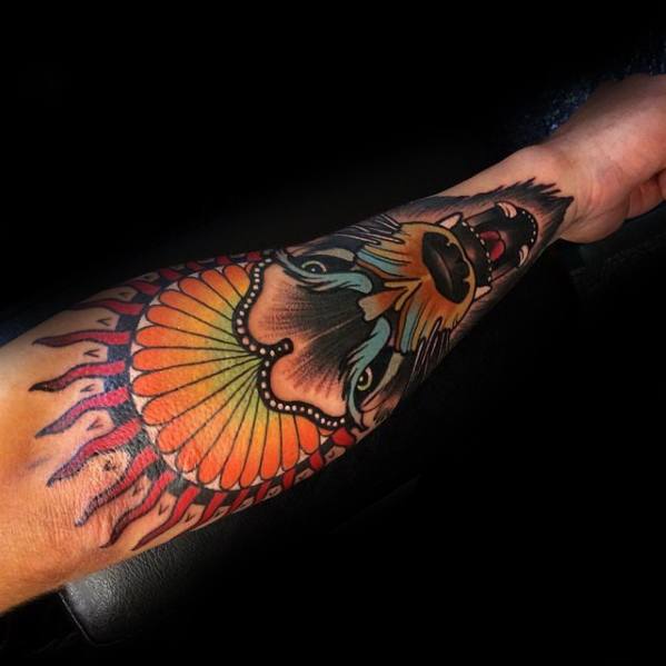 Neo-traditional tattoo of a snarling wolf with vibrant shading, a bold sunburst pattern, and intricate details on the forearm.