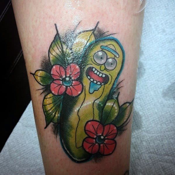 Pickle Rick tattoo with a vibrant floral design, bold outlines, and bright colors, featuring a playful expression on the leg.