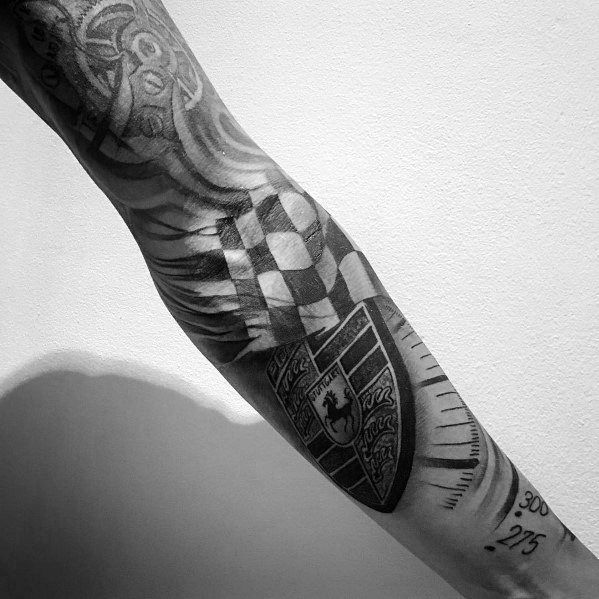 Full-sleeve Porsche tattoo featuring a crest, checkered flag, and speedometer for racing enthusiasts.