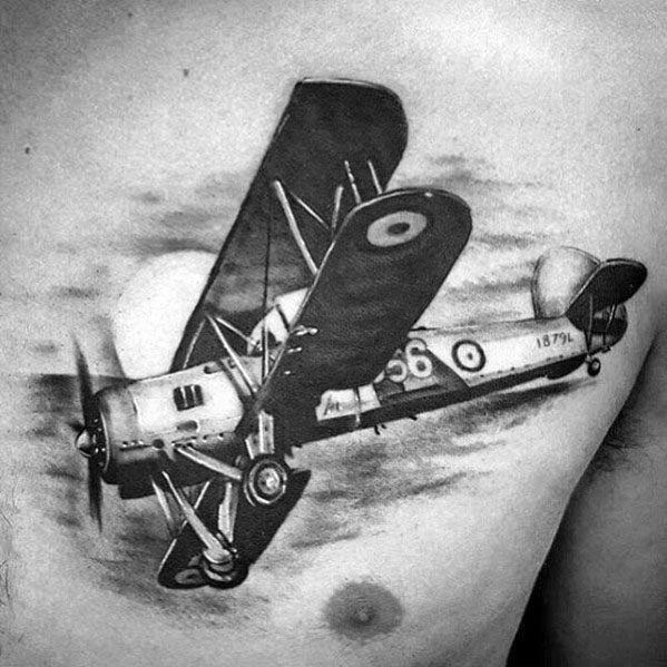 Realistic black and grey chest tattoo of a vintage biplane in flight, with fine details, shading, and a motion effect on the propeller.
