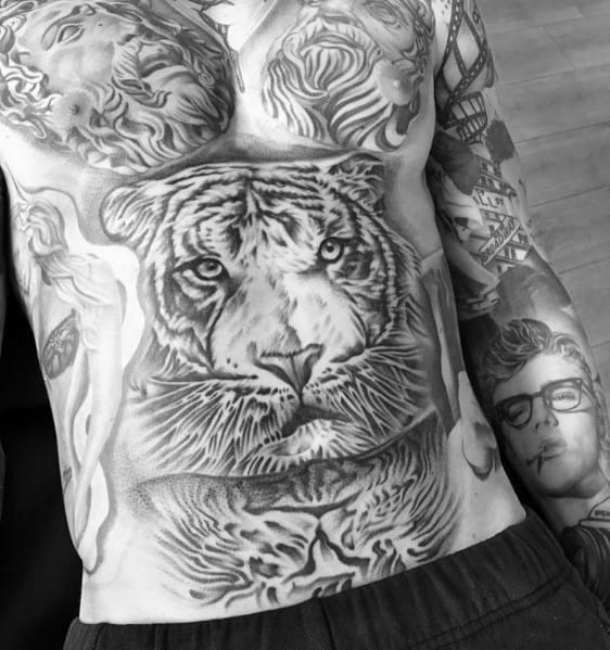 Tattoo of a fierce tiger with its reflection on the lower torso, creating a powerful and symmetrical design with intricate shading and realism.