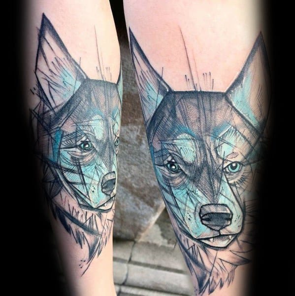 Sketch-style Siberian Husky tattoo on a man's leg, featuring bold black lines, blue shading, and an artistic, hand-drawn aesthetic.